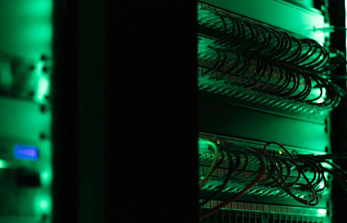 Server rack with network cables lit in green